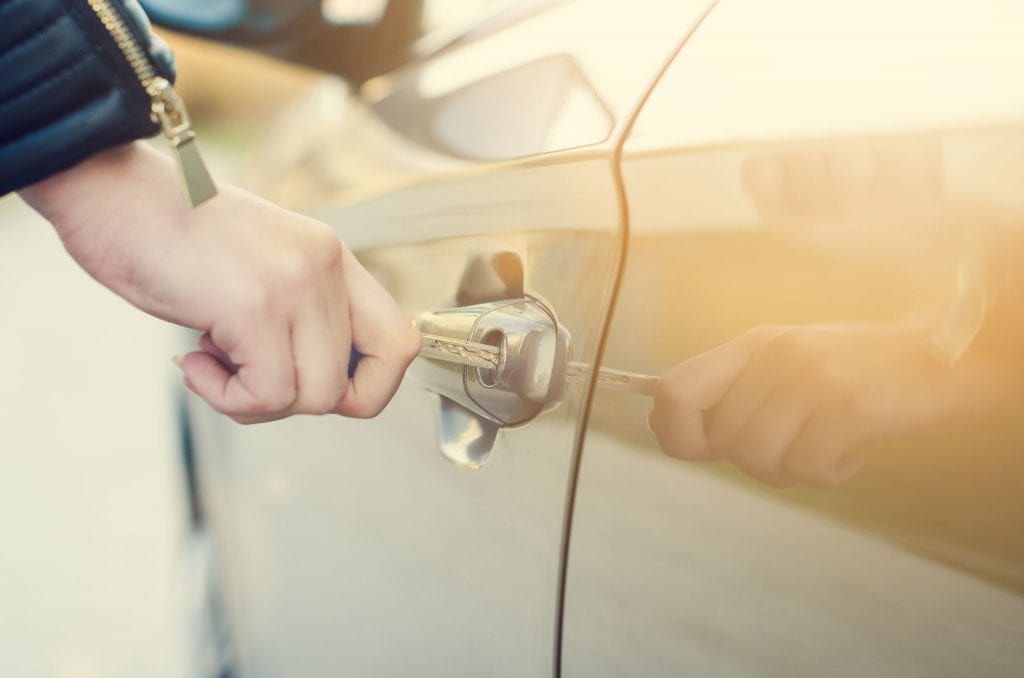 woman locking car to decreased car theft chances