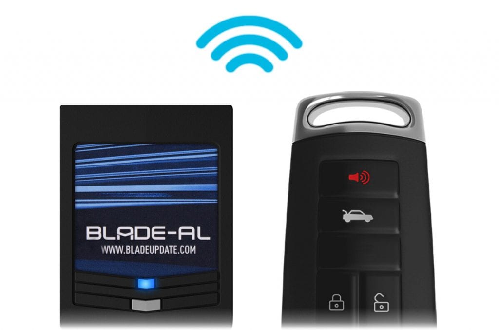 A blade-al bypass module next to a factory remote key fob. 