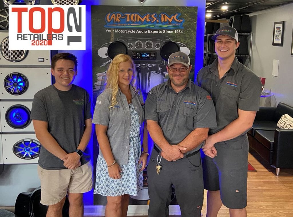 Kimberly Trainer and her team at Car-Tunes, Inc standing in their showroom. 